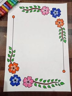 a paper with some flowers on it next to crayon markers and colored pencils