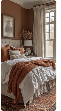 a large bed sitting under a window in a bedroom