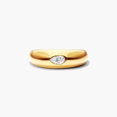 a yellow gold wedding band with a diamond in the center and a single white diamond on top