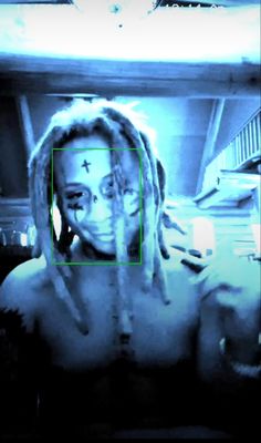 a woman with dreadlocks and cross on her face in front of a mirror