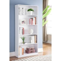 a white book shelf with books on it