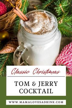 a mason jar filled with hot chocolate and topped with cinnamon on top, surrounded by christmas decorations