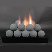 a group of rocks sitting on top of a black stand with flames coming out of them