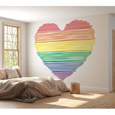 a bedroom with a large heart made out of strips of colored paper on the wall