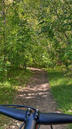 a bike is going down a trail in the woods