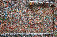 a wall covered in lots of different colored confetti