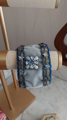 Handmade adjustable cuff created with old materials: Art Nouveau braid with gold thread and cabochon from the beginning of the 20th century, fully lined with blue satin. It is adjustable from 20.5 cm to 23 cm. The braid has been cleaned and restored. Its age gives it a unique patina and gives this cuff a charm that will only seduce you! Vintage Handmade Cuff Bracelet For Festivals, Vintage Handmade Cuff Bracelet For Formal Occasions, Handmade Vintage Cuff Bracelet For Formal Events, Handmade Vintage Cuff Bracelet For Formal Occasions, Formal Vintage Handmade Cuff Bracelet, Adjustable Bohemian Cuff Bracelet For Formal Events, Antique Adjustable Bracelets For Parties, Antique Adjustable Bracelets For Party, Handmade Victorian Cuff Bangle Bracelet