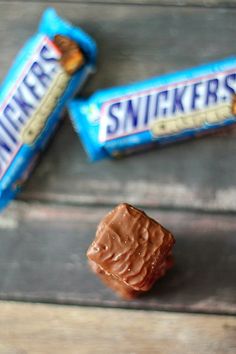 two pieces of chocolate sitting next to each other on top of a wooden table,