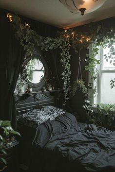 a bedroom with black walls and plants growing on the window sill over the bed