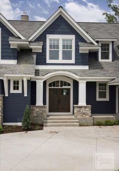 a house with blue siding and white trim on the front door is pictured in this image