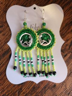 Proudly made by a Choctaw artist! Green & chartreuse, with gradient accents. These hand-beaded, native american style, medallion earrings feature a mermaid in the medallion's center.  This item is made of glass beads, backed in genuine deer hide, and fixed to silver-plated lever backs.  Please note: Because each set of my one-of-a-kind earring are handmade, minor flaws may be present. Item is sold as pictured. Medallion Earrings, Beaded Mermaid, Green Chartreuse, Deer Hide, Native American Style, Native American Fashion, Earrings Long, A Mermaid, Blue Jay