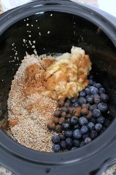 blueberries and other ingredients are in the slow cooker to make an appetizer