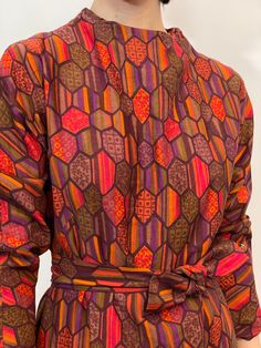 60s geometric printed long sleeve shift dress with red, green, maroon, purple, and orange, two pockets, comes w/ a belt to fit to your waist, metal zipper in the back, cotton (?). measurements taken while lying flat, double for circumference. Size S/M, Shoulders 16", waist 19.5", hips 23.5", length 40", sleeves 21", zipper 10", belt 40". good vintage condition.  Etsy Shipping Please read -Vintage and pre-owned items may have signs of wear and use and are offered as is. Traces of age and use are therefore completely normal and do not constitute defects. Please see pictures as they are part of the item description and refer to sizes/measurements provided. measurements are taken Flat, double for circumference. Please contact me if you want more information and/or pictures.  All sales are fina Belted Multicolor Dresses For Fall, Cotton Belted Long-sleeved Dress, Colorful Long Sleeve Dress For Fall, Vibrant Printed Fall Dress, Purple Printed Fall Dress, Purple Printed Dress For Fall, Multicolor Long Sleeve Dress With Vintage Print, Multicolor Long Sleeve Dresses With Vintage Print, Long Sleeve Multicolor Dress With Geometric Pattern