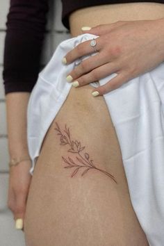 a woman's stomach with a flower tattoo on it