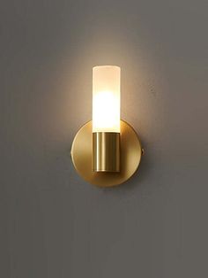 a light that is on the side of a wall in a room with gray walls