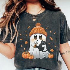 Halloween Ghost and Black Cat Comfort Colors Shirt, Cute Ghost Shirt, Womens Halloween Shirt, Cute Fall Shirt, Spooky Season Shirt Experience ultimate comfort with the softest t-shirt you'll ever own. This classic unisex jersey short sleeve tee fits like a cherished favorite. Crafted from soft cotton with high-quality prints, it's a piece you'll fall in love with repeatedly. Featuring ribbed knit collars for enhanced shaping and taped shoulders for a better fit over time, dual side seams ensure Black Cartoon Print Shirt For Halloween, Cat Comfort, Cute Fall Shirt, Ghost Cat, Ghost Shirt, Dtf Printing, Comfort Colors Shirt, Black Cat Halloween, Fall Shirt