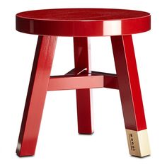 a red stool with gold trim around the legs