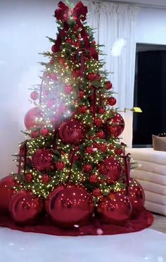 a christmas tree with red ornaments and lights