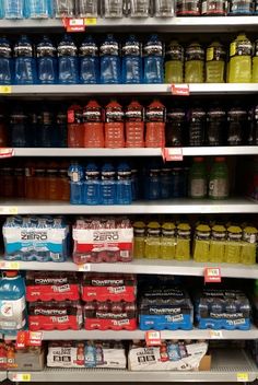 the shelves are filled with many different types of sodas and soft drinks in cans