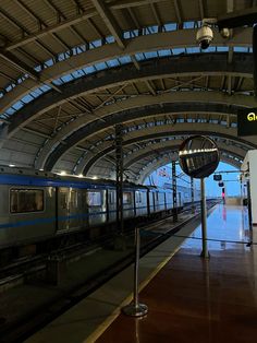 a train is pulling into the station with its doors open