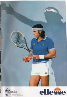 a man holding a tennis racquet on top of a tennis court with the shadow of a person behind him