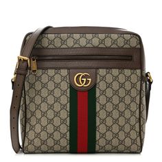 This is an authentic GUCCI GG Supreme Monogram Web Medium Ophidia Messenger Bag in Brown. This camera-style crossbody bag is crafted of monogram coated canvas, with brown leather trim. The bag features an adjustable brown leather shoulder strap, a front zipper pocket with a green and red web stripe detail, and an aged gold Gucci GG logo. The top zipper opens to a natural linen fabric interior with zipper and patch pockets. Gucci Coated Canvas Bag With Logo, Designer Brown Shoulder Bag In Signature Coated Canvas, Gucci Brown Leather Shoulder Bag, Gucci Signature Coated Canvas Travel Shoulder Bag, Gucci Shoulder Bag In Signature Coated Canvas For Everyday, Gucci Brown Shoulder Bag With Leather Trim, Gucci Brown Shoulder Bag With Adjustable Strap, Gucci Leather Lined Travel Shoulder Bag, Designer Brown Monogram Canvas Shoulder Bag