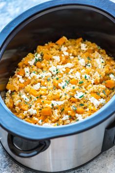 a crock pot filled with rice and vegetables