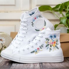 Customized Embroidered Converse Shoes, Blue Flower Embroidered Shoes Custom, Flower Embroidered Sneakers for Women, Mother's Day Gift 💚 Immerse yourself in the intricate craftsmanship as we lovingly hand embroider rustic flowers onto your chosen Converse pair 💚 🌿 The listed price encompasses both the Converse Shoes and the showcased Embroidery Designs. 1. MANUFACTURING PROCEDURE 🌿 Upon receiving your order, we initiate the shoe preparation process. If your chosen shoes are readily available Embroidered Sneakers For Wedding, Wedding Low-top Sneakers With Floral Embroidery, Spring Wedding Embroidered Sneakers, White Wedding Sneakers For Summer, White Sneakers With Appliques For Summer, Spring Wedding Shoes With Embroidery And Closed Toe, White Embroidered Sneakers For Summer, Spring Wedding High-top Sneakers, Spring Wedding Shoes With Embroidered Closed Toe