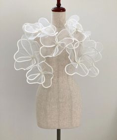 a mannequin with white flowers on it