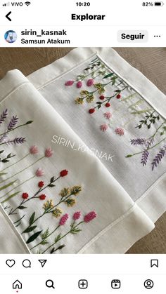 two embroidered napkins with flowers on them, one is white and the other is pink