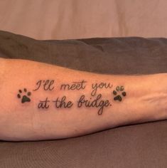 a person with a dog paw tattoo on their arm that says, i've met you at the bridge