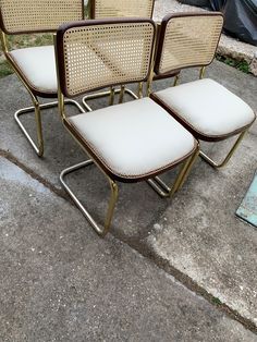 four chairs sitting next to each other on concrete