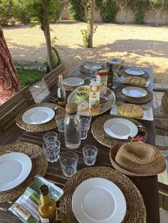 the table is set with plates and glasses