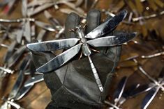 a pair of gloves with knives stuck in them