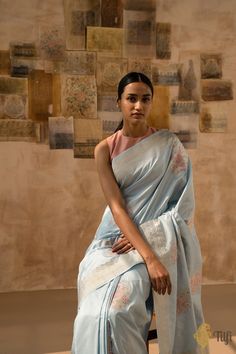 "Guldasta\nA\u00a0joyful display of tradition and creativity.\u00a0Rooted in heritage, this delicate Banarasi drape exudes timeless sophistication. Meticulously\u00a0crafted\u00a0in the exquisite kadwa weave with rose borders\u00a0in gold zari and colourful floral bootas in masterly meenakari, this piece\u00a0is\u00a0Banarasi delicacy at its finest.\n\u00a0\n\n\nColor\u00a0- An elegant shade of\u00a0Light Blue\n\nTechnique\u00a0-\u00a0An enduring Kadwa weave and fine Meenakari technique. The elaborate and laborious Kadwa (Kadhua) technique involves hand-weaving each motif separately. It takes longer on the handloom, but makes a more robust pattern, which stands out on the fabric. Meenakari involves the painstaking addition of supplementary coloured resham threads during the hand-weaving pr Luxury Katan Silk Handloom Pre-draped Saree, Luxury Cotton Silk Saree With Border, Saree Painting Designs, Blue Silk Saree, Banaras Sarees, Beautiful Sarees, India Dress, Shades Of Light Blue, Saree Photoshoot