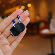 "This is a black onyx dangle earrings with round shaped black onyx and natural blue lapis lazuli in geometric design. It's modern and boho style.  Material: 925 Sterling Silver Gold Plated Gemstone: Natural Black Onyx & Lapis Lazuli Don't forget to find more designs from our shop: https://www.etsy.com/hk-en/shop/NikiFashionJewelry Be sure to hit \"favorite\" on the right so it remains in your favorites list and/ or add to your wish list(s). Hope you enjoy my designs. ❤PIN IT on PINTEREST ❤FOLLOW Trendy Black Clip-on Earrings As Gift, Trendy Black Clip-on Earrings, Trendy Black Earrings For Gift, Modern Black Single Earring, Black Single Drop Earring, Black Enamel Drop Earrings For Party, Black Enamel Metal Earrings, Modern Black Round Jewelry, Black Onyx Earrings For Parties