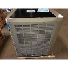 an air conditioner sitting on pallets in a warehouse