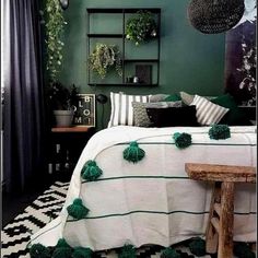 a bedroom decorated in green and white with pom - poms on the bed