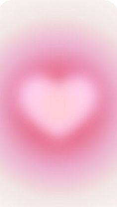 a blurry image of a pink heart in the middle of it's frame