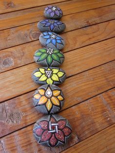 a row of painted rocks sitting on top of a wooden floor