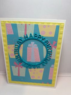 a birthday card with the word happy birthday written in blue and pink on it's center