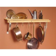 pots and pans are hanging on a shelf