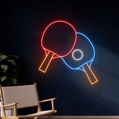 two ping pong paddles are glowing against a dark wall with a chair in the foreground