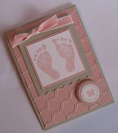 a baby's hand and foot print on a pink card