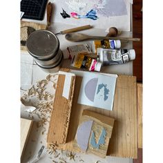 some art supplies sitting on top of a table with paintbrushes and other items