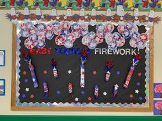 a bulletin board with firework and fireworks on it in front of a classroom wall