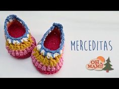 crocheted baby shoes with the words mercedita's written on them