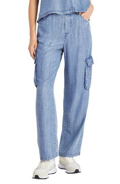 Lightweight chambray pants feature a comfortable elastic waist, wide legs and trendy cargo pockets for a look you'll love. 31 1/2" inseam; 9" leg opening; 10" front rise; 13 1/2" back rise Zip fly with button closure; elastic waist Five-pocket style; cargo flap-patch pockets 100% lyocell Machine wash, tumble dry Imported Chambray Pants, Lyocell Fabric, Style Cargo, Women Cargos, Cargo Pants Women, Wide Legs, Premium Brands, Simple Shapes, Trouser Pants