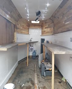 the inside of a building that is being remodeled with wood paneling and exposed lighting