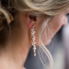 a close up of a woman's ear wearing earrings